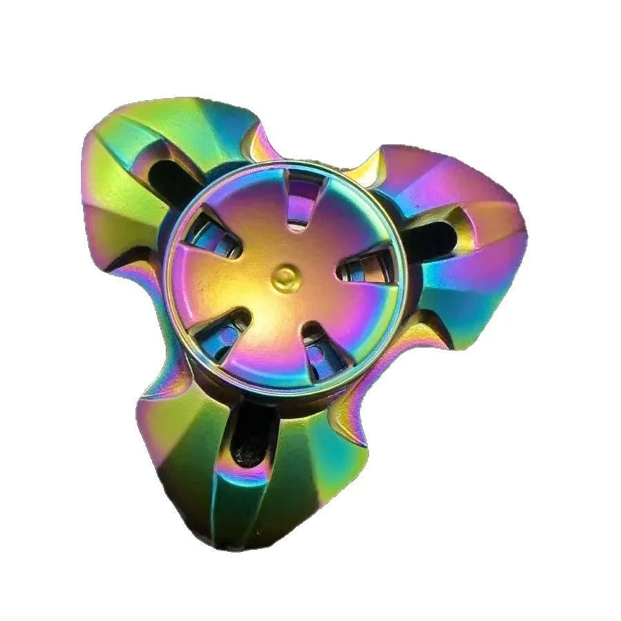 Alloy decompression fingertip gyro toy in gun colour finish on a dark background