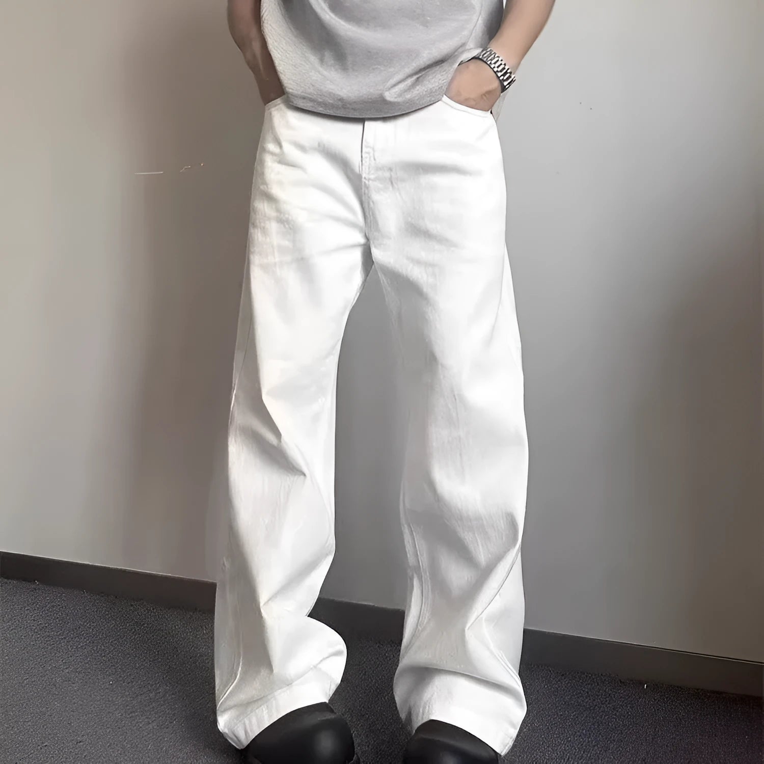 Men's loose fit straight leg white denim jeans on a hanger, showing wide leg opening and zipper fly.