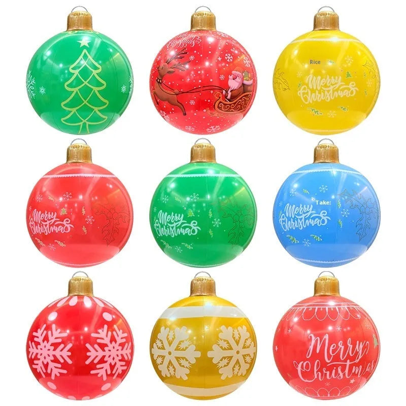Large red inflatable Christmas ball with LED lights in a garden setting