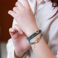 Blue water jade abacus beads bracelet with tourmaline and pearl three-ring design on wrist