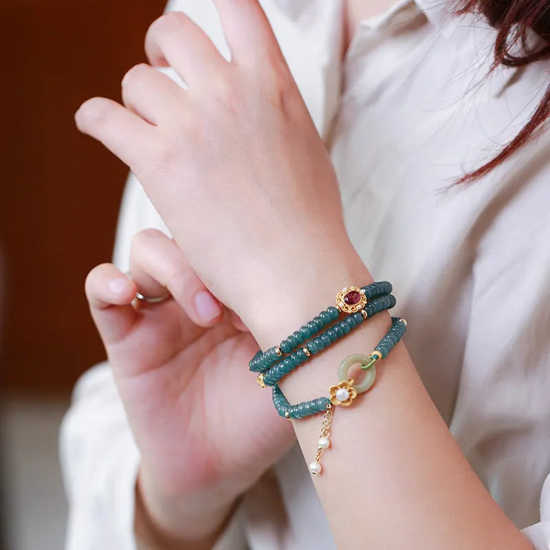 Blue water jade abacus beads bracelet with tourmaline and pearl three-ring design on wrist