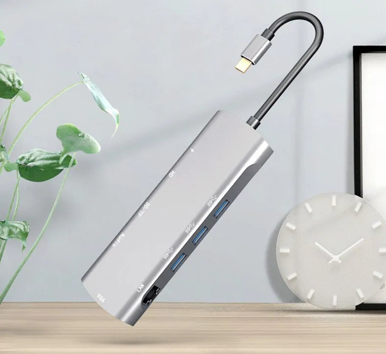 Grey aluminium USB-C docking station with HDMI, VGA, USB 3.0, and charging ports