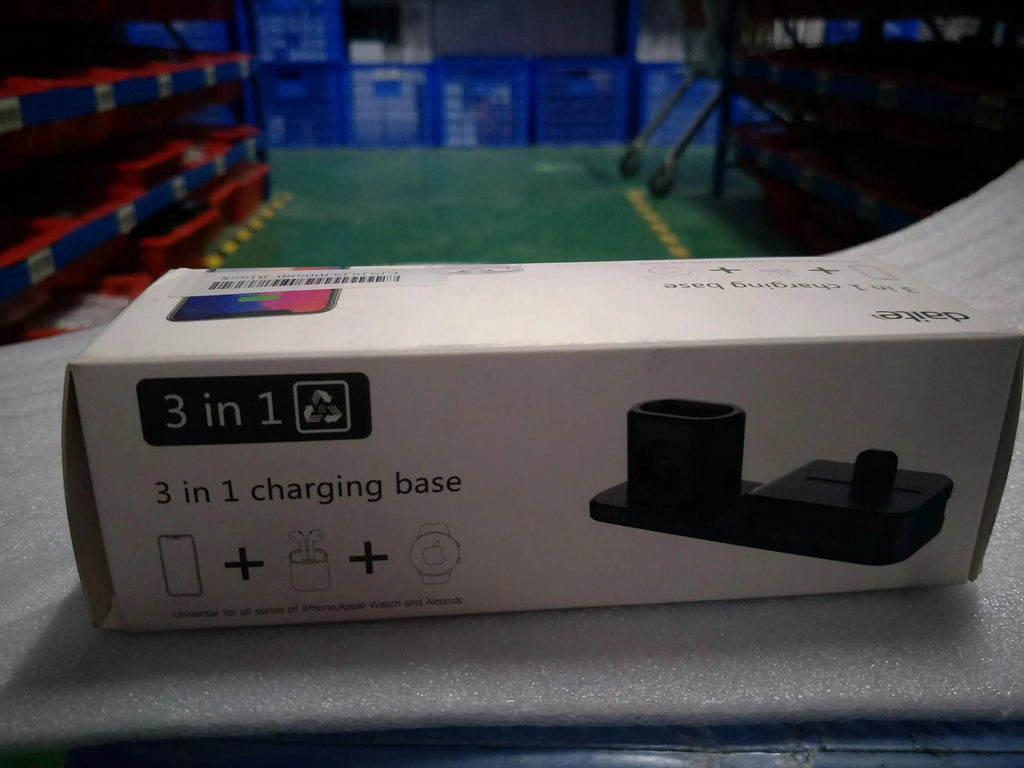 Black 3-in-1 silicone charging base for iPhone, iWatch, and AirPods on a desk
