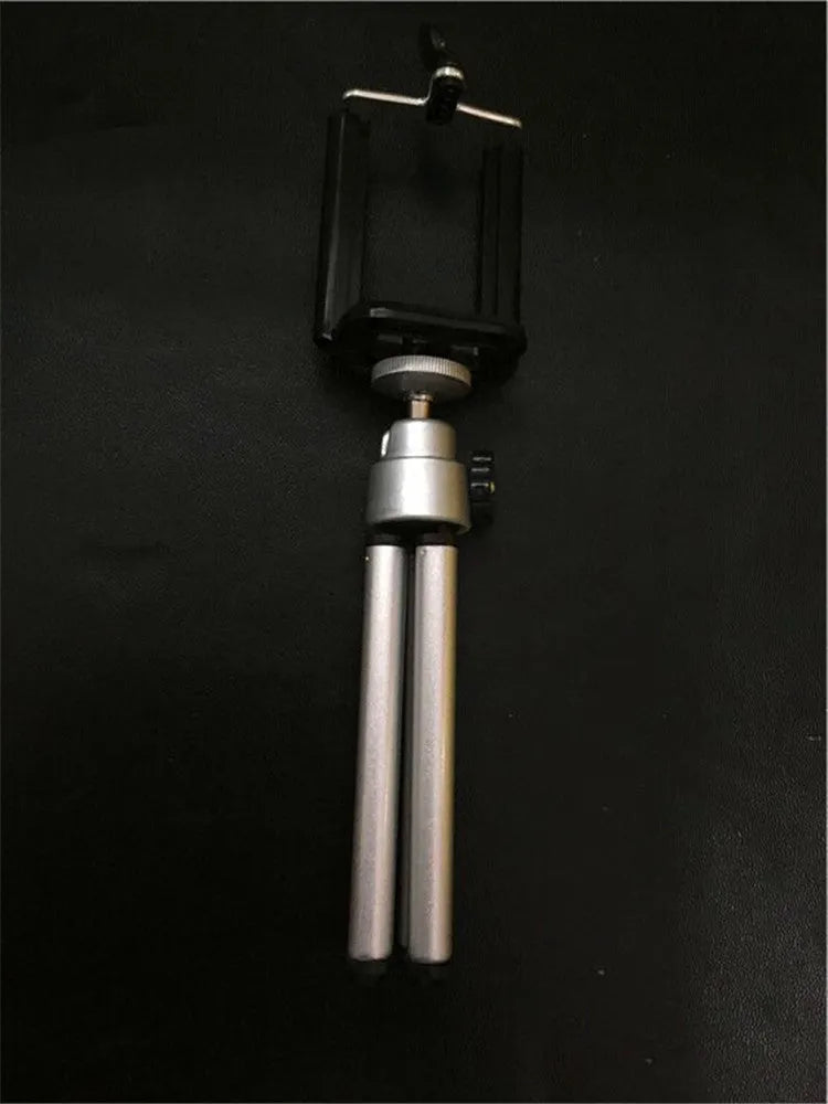 Black desktop phone holder with two-section metal bracket on office desk