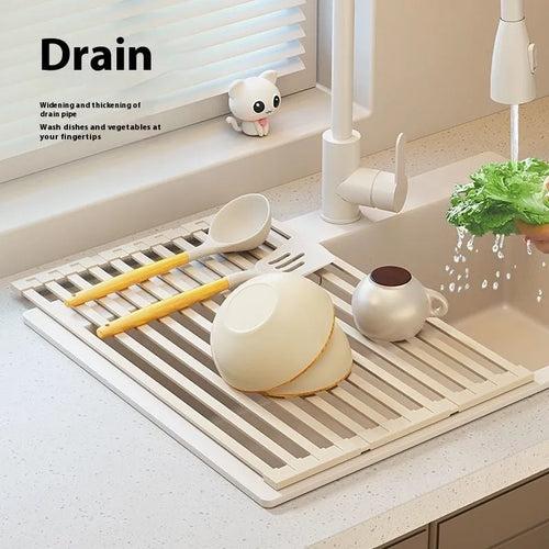 Milky white foldable stainless steel kitchen draining rack placed next to a sink.