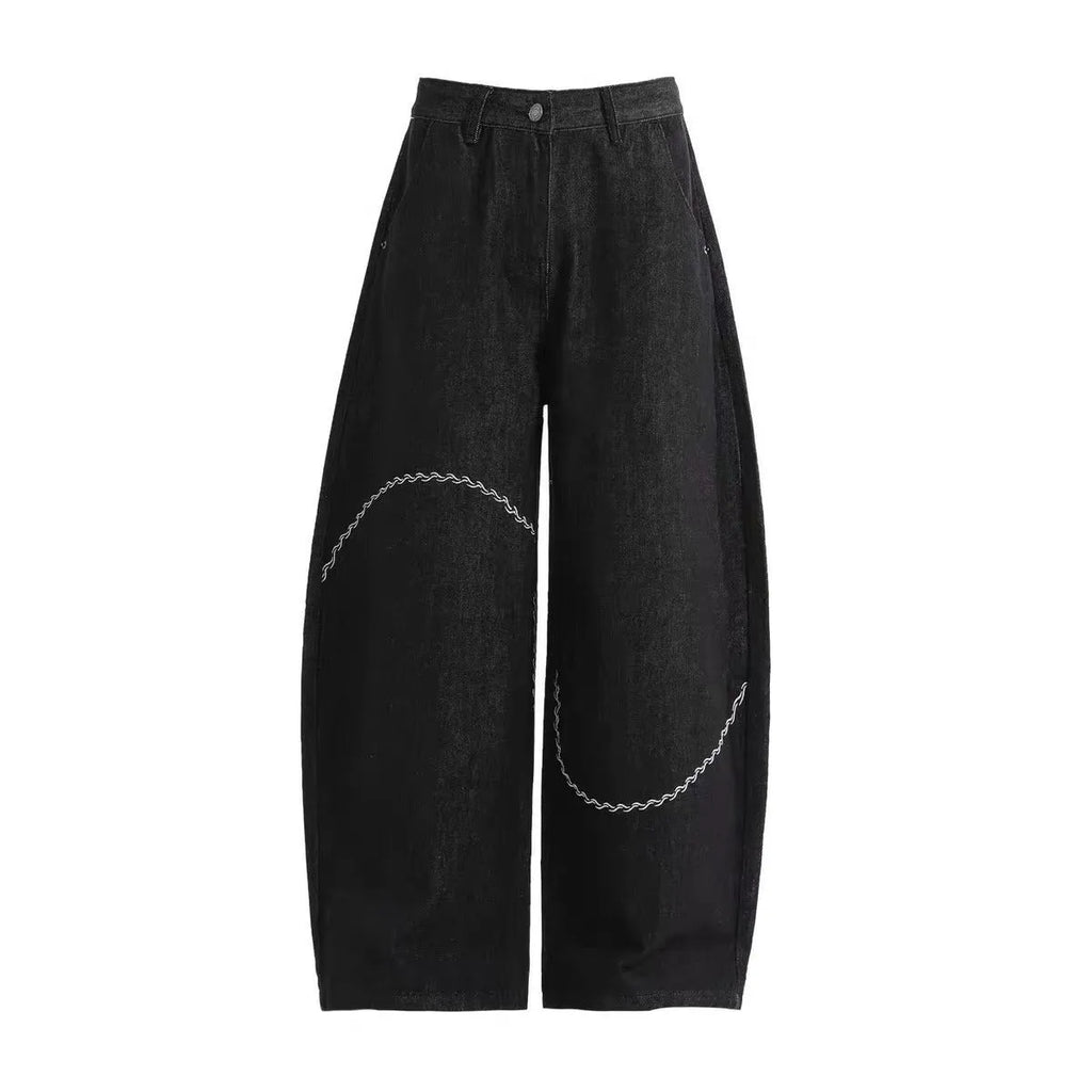 Black straight-leg denim trousers with mid waist and zip placket closure on hanger