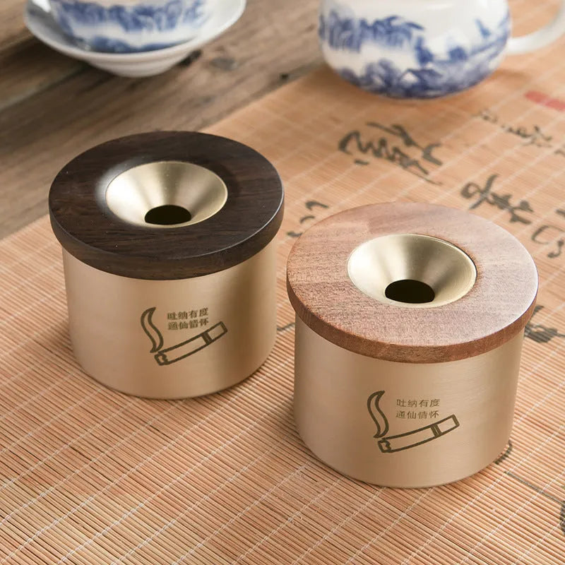 Brass ashtray with wooden lid showing central aperture design
