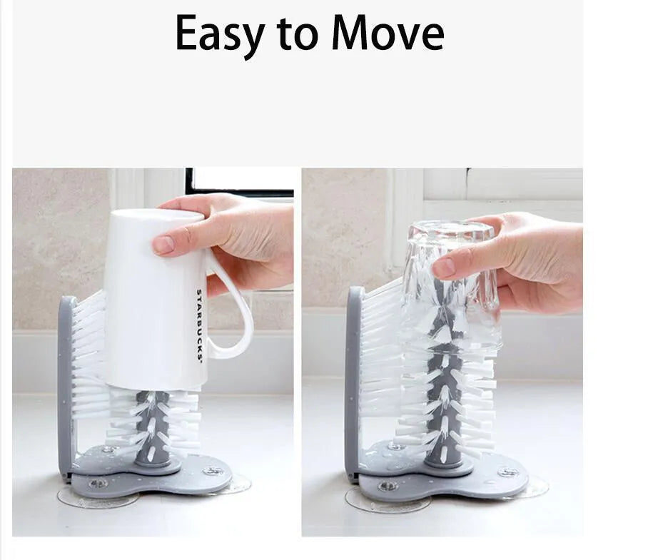 Grey suction cup brush with double-head design and two suction cups on a kitchen wall