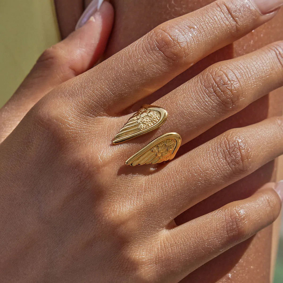 Adjustable stainless steel wings ring with opening design in electroplated gold finish