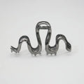 Slytherin serpentine metal hair clip in silver, 10.5cm, on flat surface