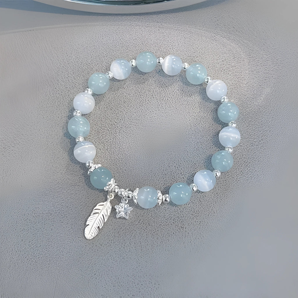 Small white girl crystal bracelet in feather XINGX blue moonlight with eight Awn star motif on wrist