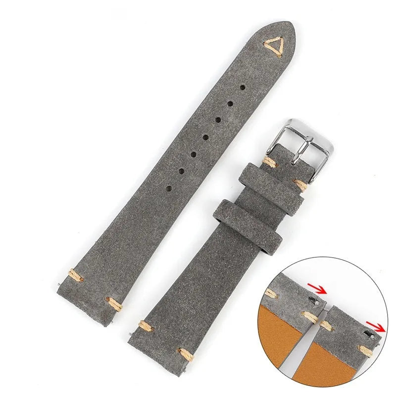 Brown genuine suede leather watch strap showing textured surface and buckle, laid flat.