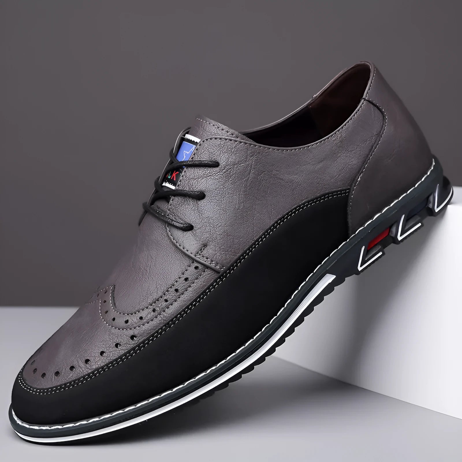 Men's black leather casual shoes with a low top, rubber sole, and sewing line detail on a fabric upper.