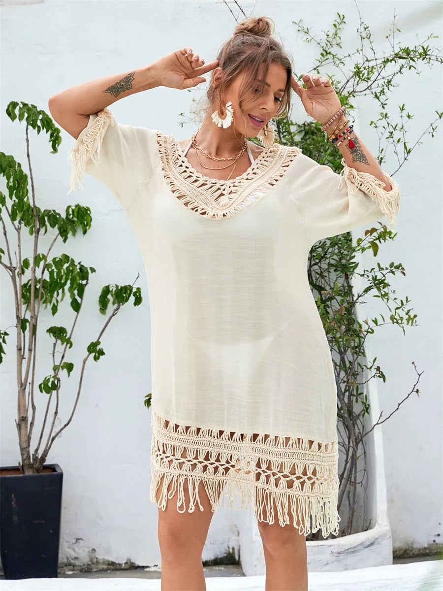 Apricot coloured hand-crocheted women's beach dress on a hanger