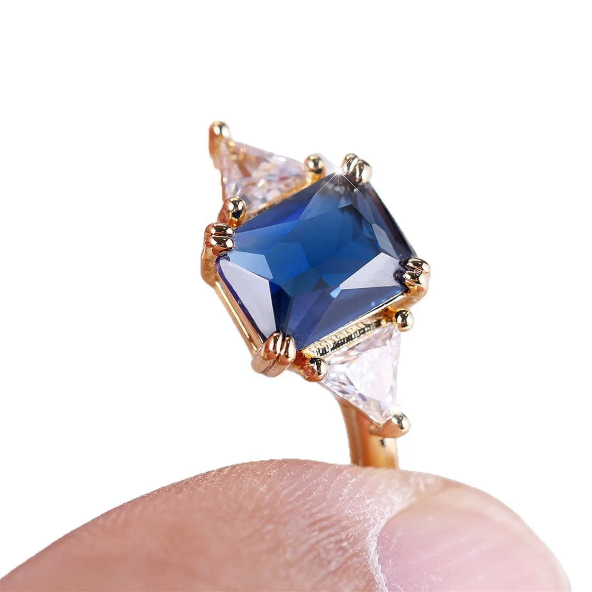 Ladies rectangular copper fashion ring in gold sapphire blue finish on finger