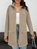 Women's loose casual mid-length cardigan coat in black with side pockets on a model