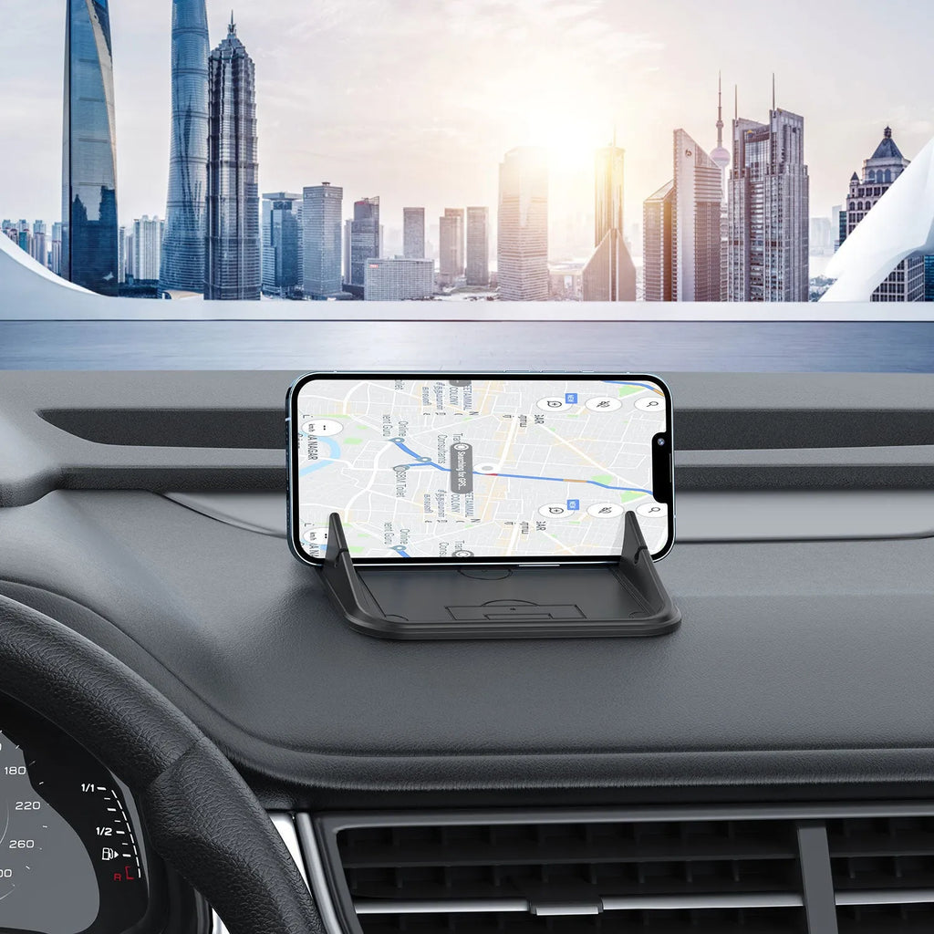 Grey silicone car phone holder Peak-X5 on dashboard with mobile phone inserted