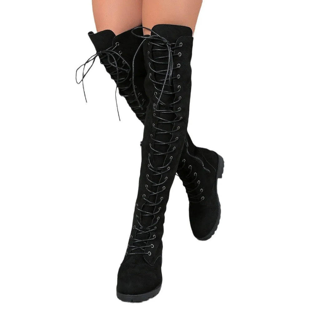 Black lace-up over the knee boots with round toe and flat rubber sole on a white background.