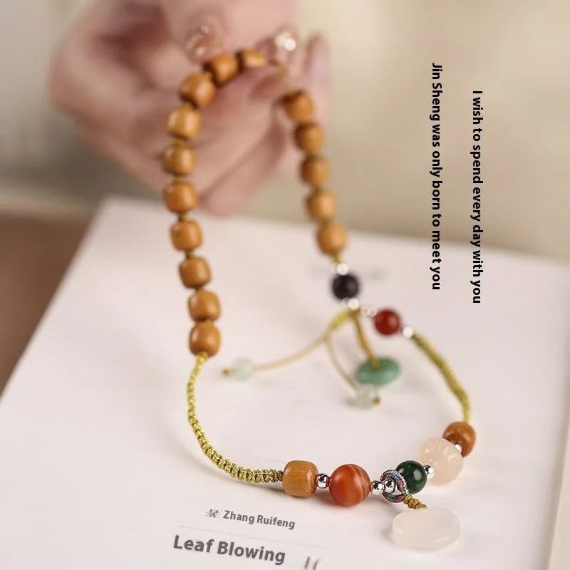 Women's ebony hand-woven double ring bracelet with Ruyi motif, available in Xiuyan jade colour