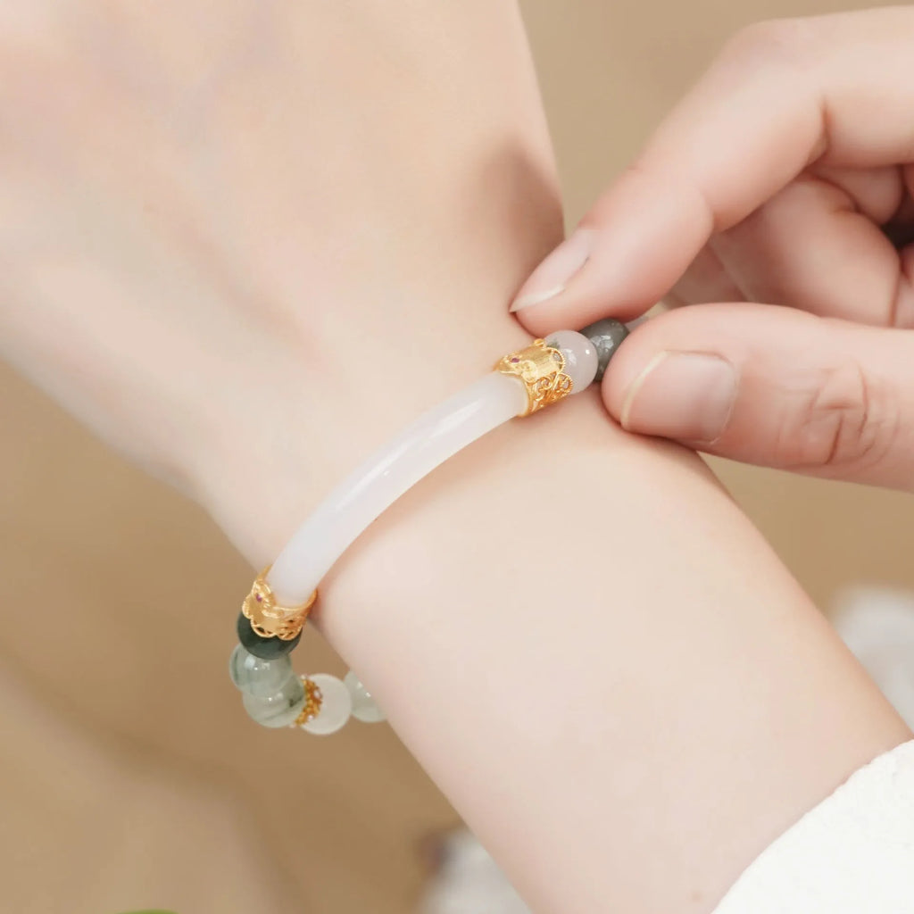 Light green emerald Tian Shan Cui half bracelet with floating flower girl motif on white background
