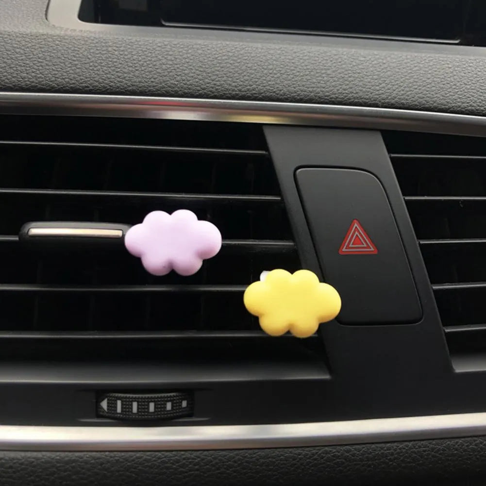 Resin cartoon car fragrance clip in one of six colours attached to vehicle air vent