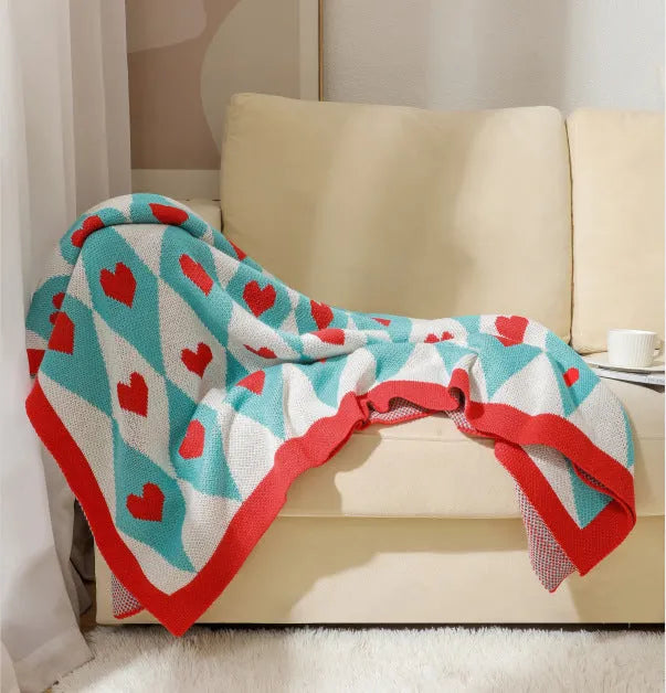 Bohemian style acrylic sofa throw blanket with tassel trim in a geometric pattern colour