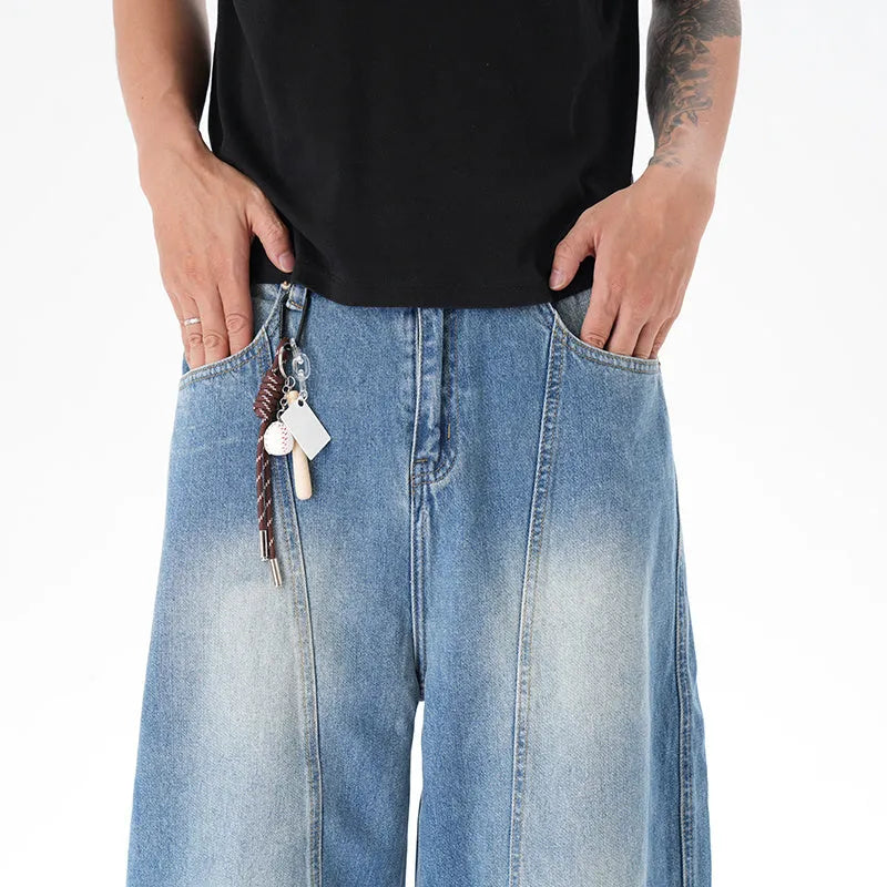 Light blue wide leg machete jeans with vintage washed denim finish, zip-fly closure, cut wash effect