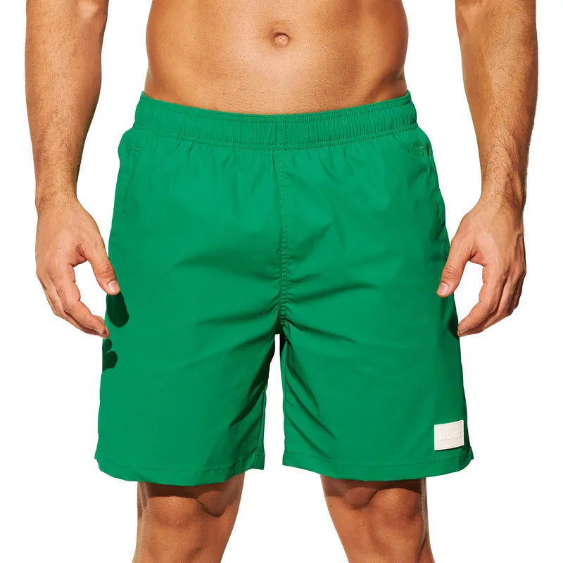 Men's quick-dry nylon swim shorts in solid colours with straight leg opening