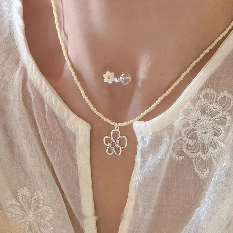 Women's colourful beaded hollow flower necklace with copper pendant, electroplated finish, on display.