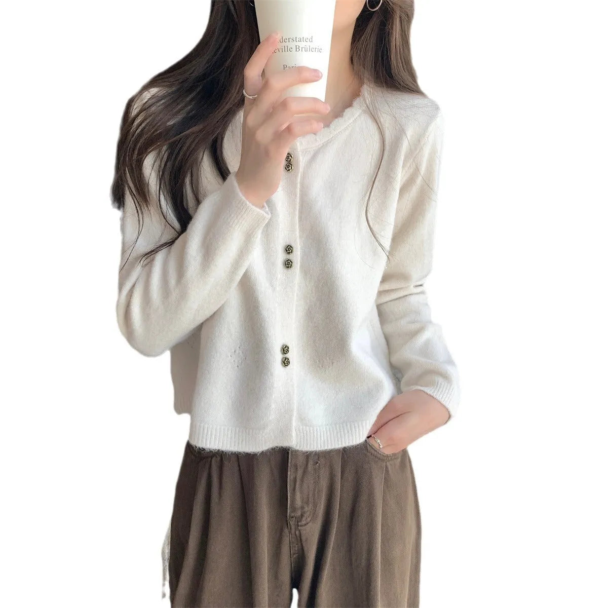 Women's long-sleeved acrylic cardigan coat in milky white, shown as a casual layering piece.