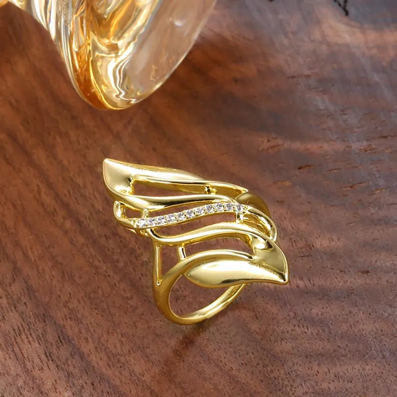 Gold copper casual curve ring for women with zircon decoration on white background