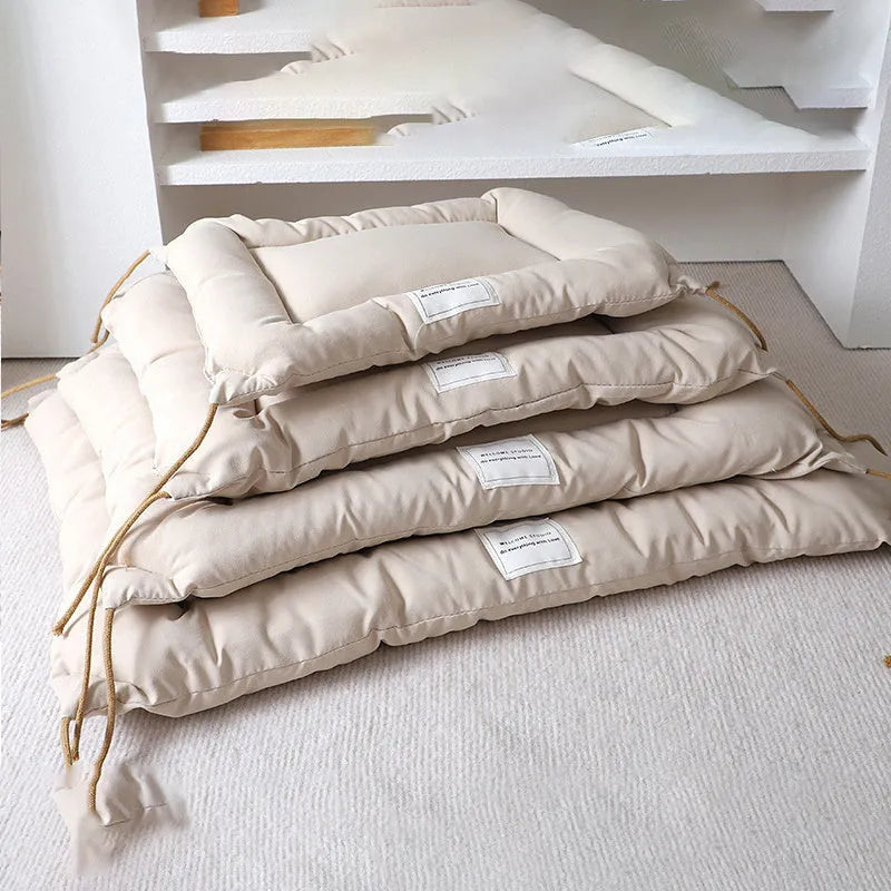 Tied cage cushion for dogs and cats in beige, showing platform attached to wire crate bars – size L.
