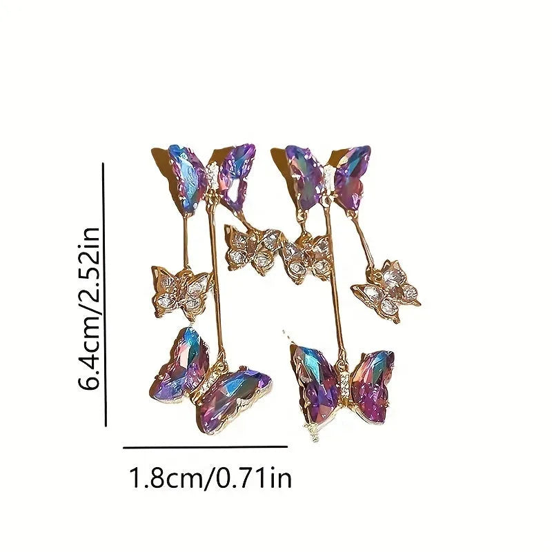 Close-up of women's silver needle blue purple butterfly tassel earrings with crystal flowers on alloy.