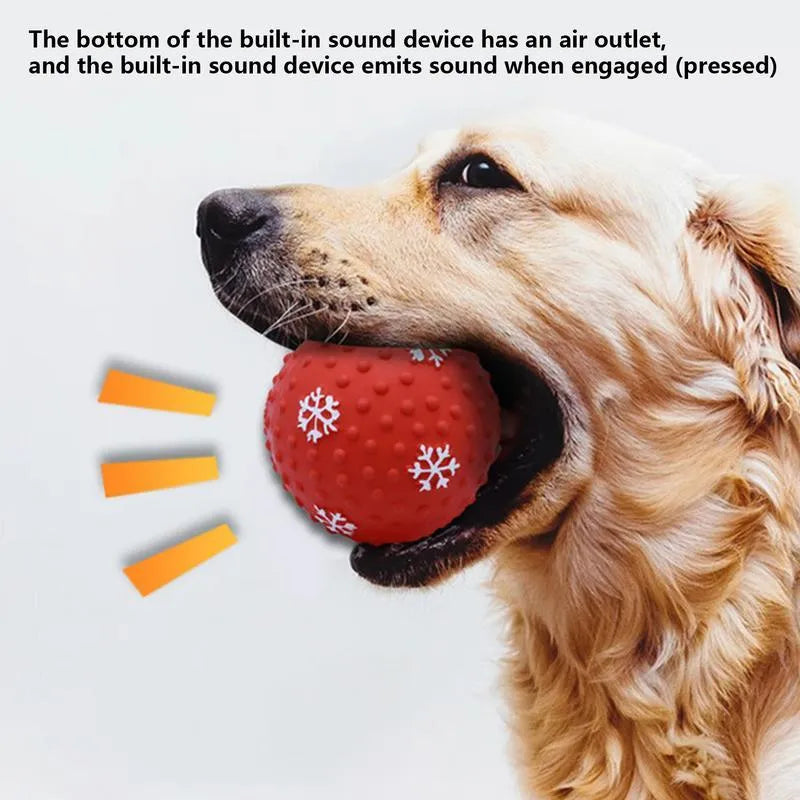 Red dog toy ball with snowflake print pattern, 7cm diameter, bouncing on grass