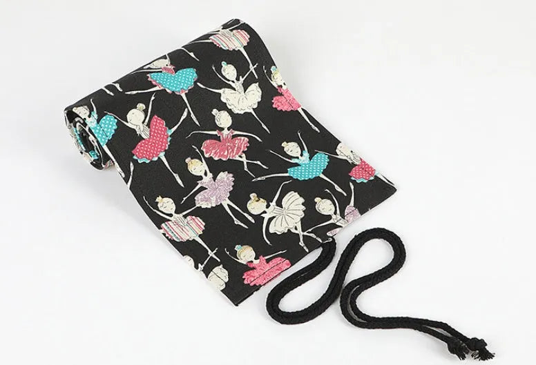 Square canvas pencil case with ballet girl print, showing multiple holes for organising pencils and stationery.