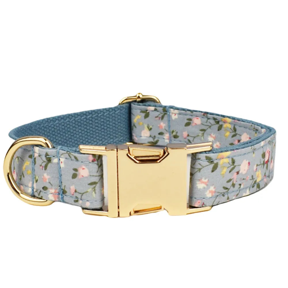 Blue floral dog collar with matching bow accessory on white background
