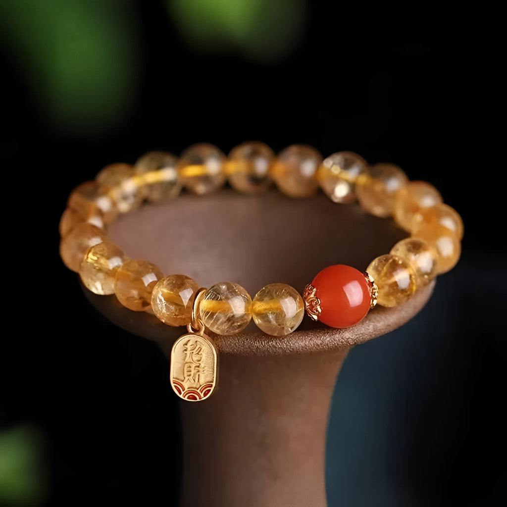 Natural red agate bracelet with gold ruby beads on a light background, polished finish, 8mm size