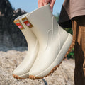 Men's mid low tube rain boots with non-slip sole and PVC upper in black