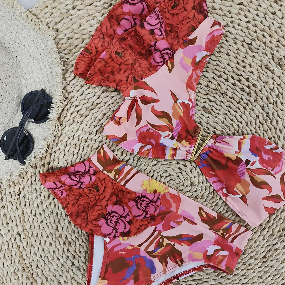 Women's pink floral print bikini with one-shoulder ruffled design and high-waisted briefs