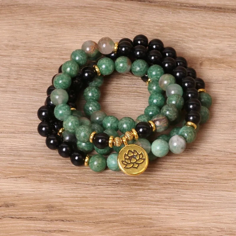Green and black alloy beaded elastic bracelet laid flat showing alternating colour pattern
