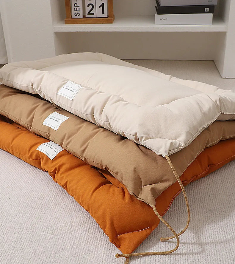 Tied cage cushion for dogs and cats in beige, showing platform attached to wire crate bars – size L.
