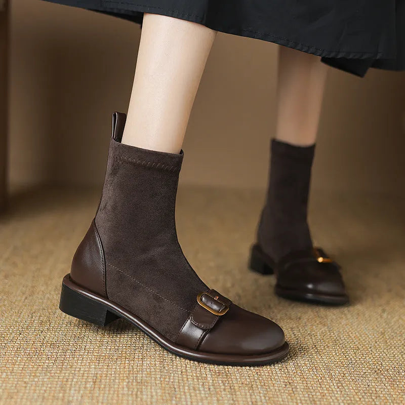 Women's black low heel Martin ankle boots with belt buckle stitching and lace-up front.