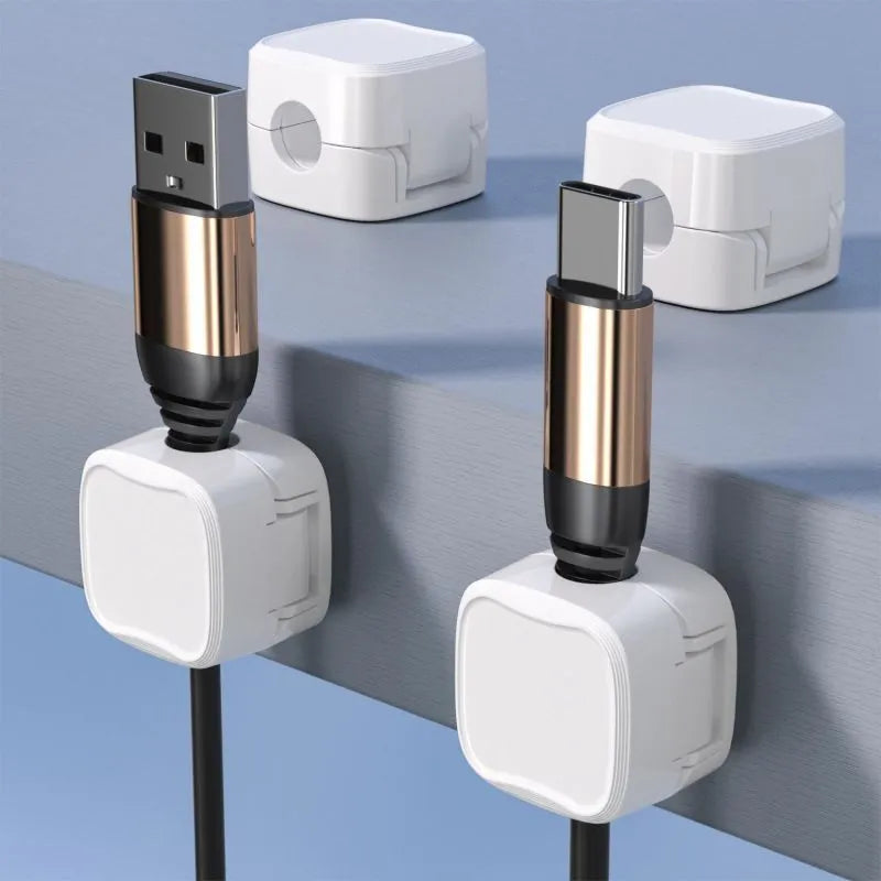 White and black cable clips holding under desk wires including USB and HDMI cables
