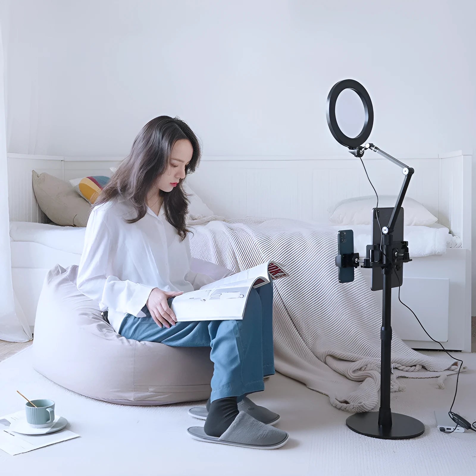 Black aluminium alloy floor stand holding a mobile phone with built-in fill light switched on