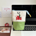 Brown and green cartoon design collapsible pencil case with zipper, showing flat and expanded states.