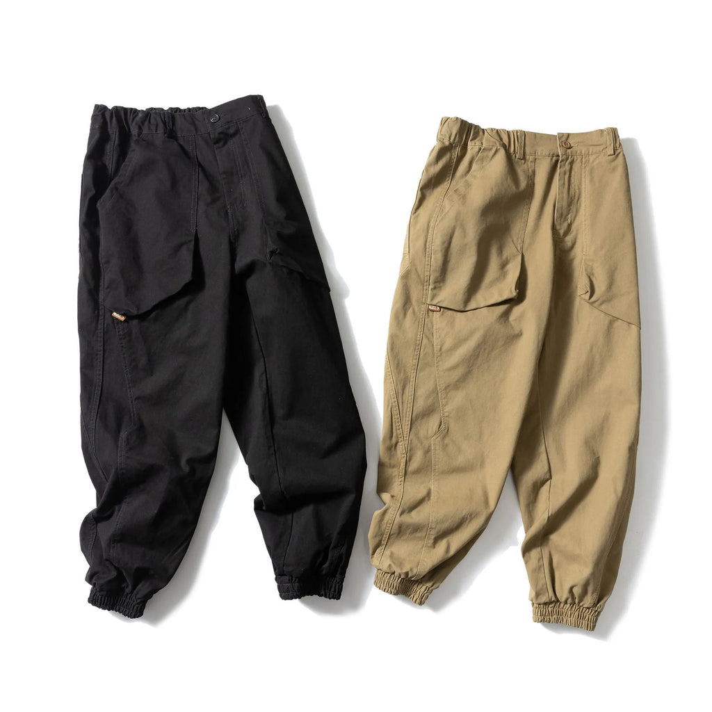 Solid colour cotton tapered casual pants with ankle ties, loose fit, available in black and khaki.