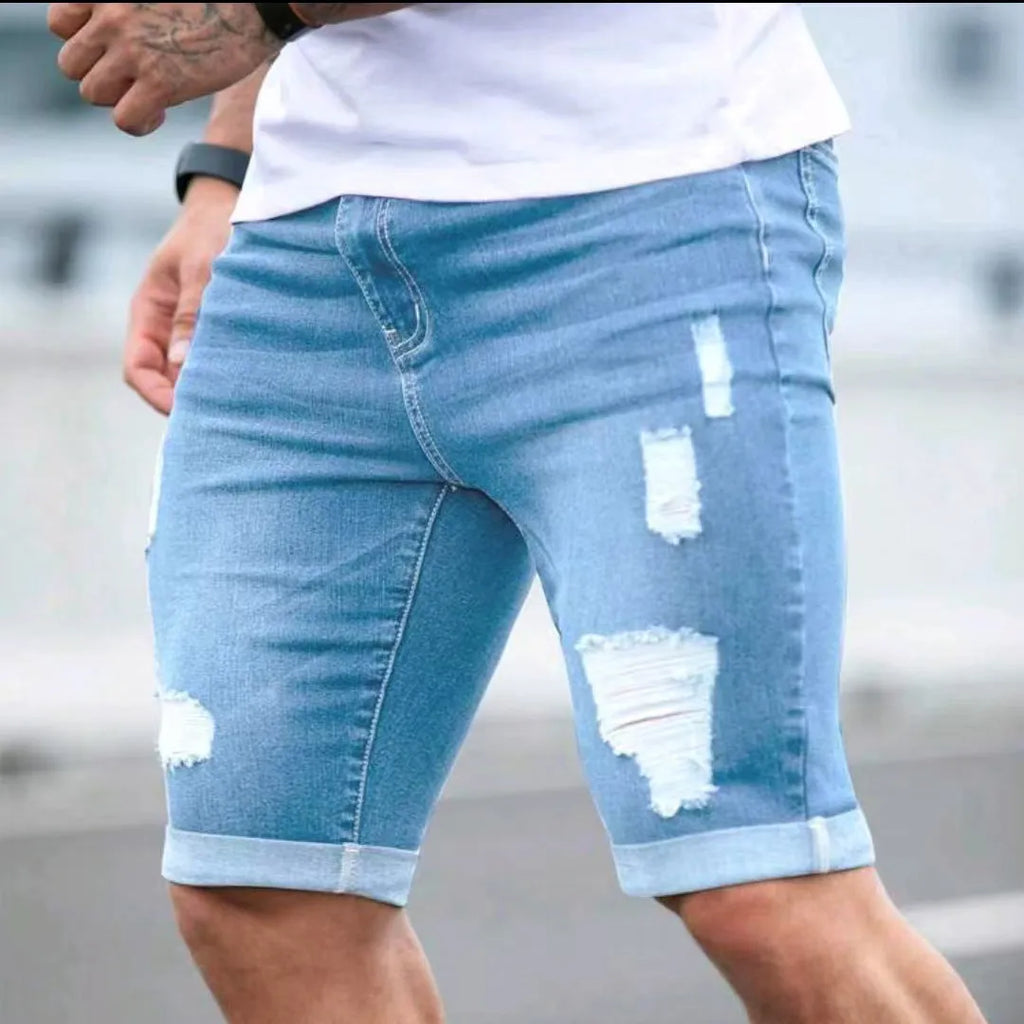 Men's sky blue denim shorts with multi-hole design, low waist, straight fit, and zipper fly on a hanger