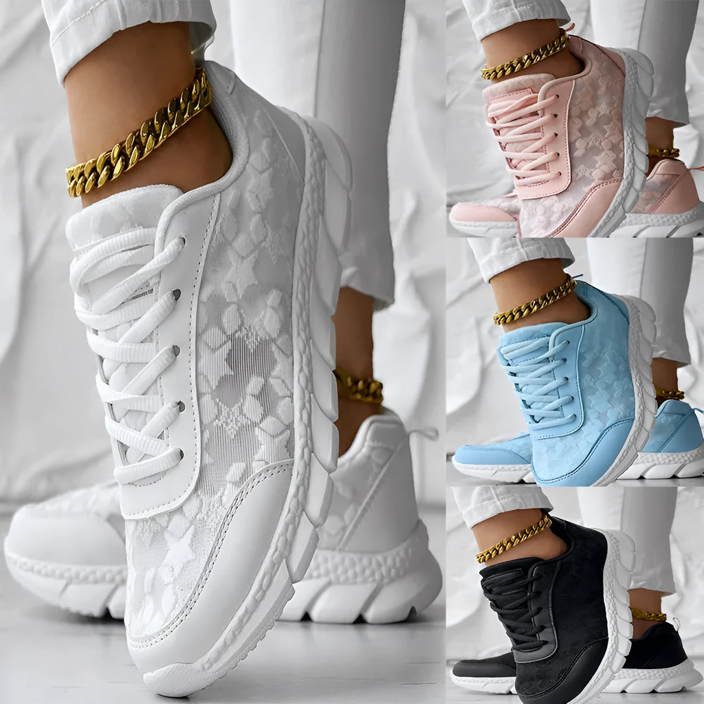 Women's white canvas casual sports shoes with a round toe and flat soft sole on a plain background.