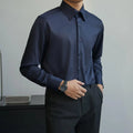 Man wearing a black long sleeve Korean-style cardigan shirt with a loose fit.