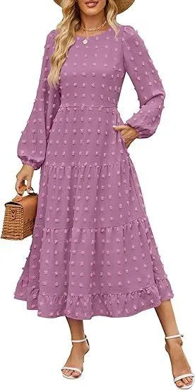 A woman wearing a beige high waist long sleeve dress with ruffle details on a autumn day.